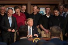 Scott Pruitt, left, administrator of the Environmental Protection Agency, with President Trump and a group of coal miners in March as the president signed an executive order that rolled back many climate-change policies. Credit Stephen Crowley/The New York Times